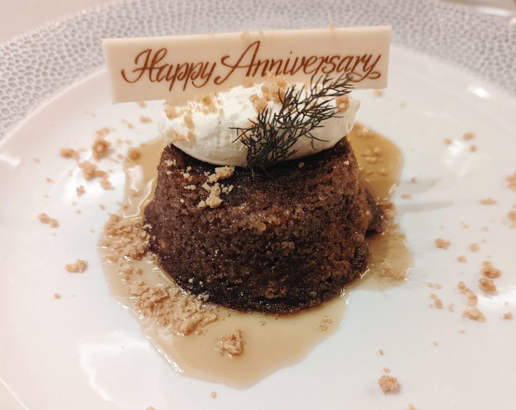 brown sponge cake with a happy anniversary chocolate on top