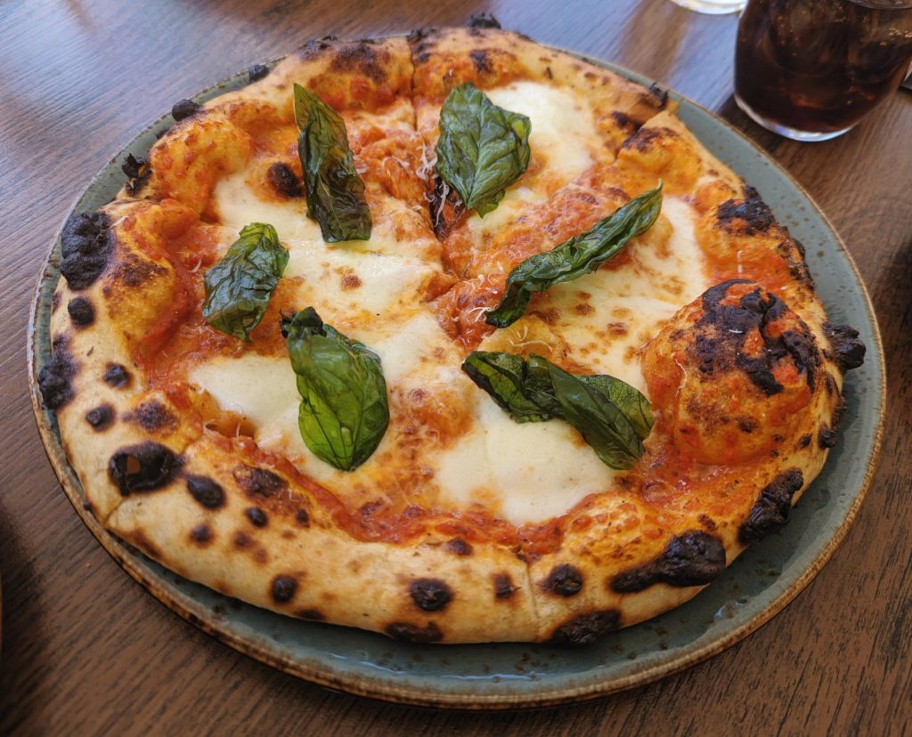 Margherita pizza with large basil leaves