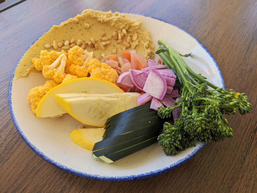 Humus and vegetables - squash, broccolini, zucchini, radishes, and cauliflower