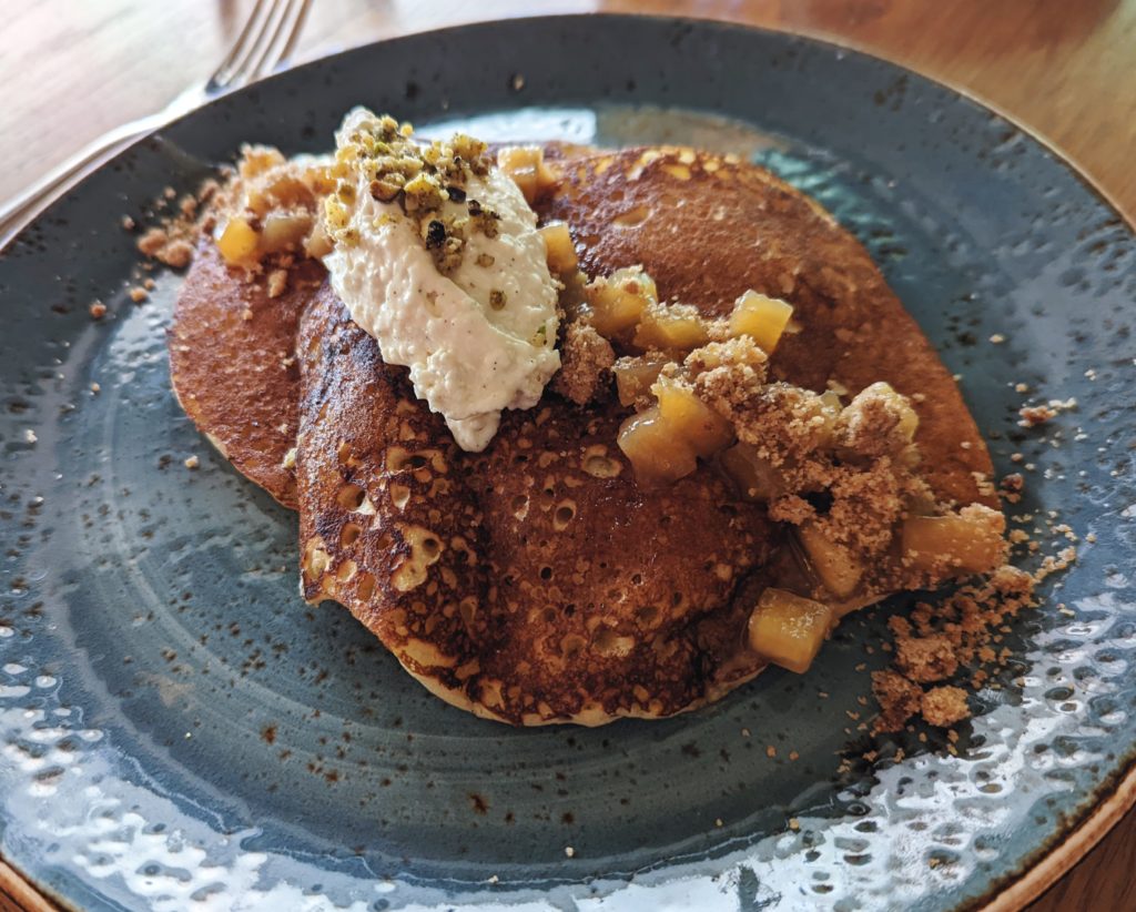 cinnamon apple pancakes with sliced apples on top