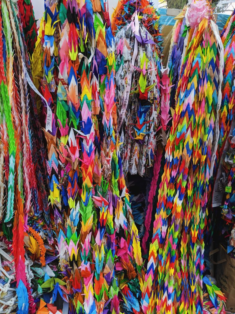 Hundreds of colorful origami cranes strung together