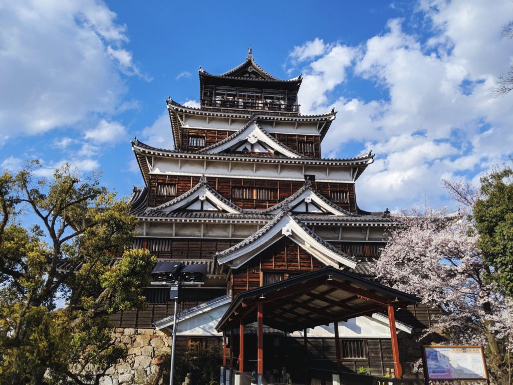 Looking up at Hiroshima castle during cherry blossom season