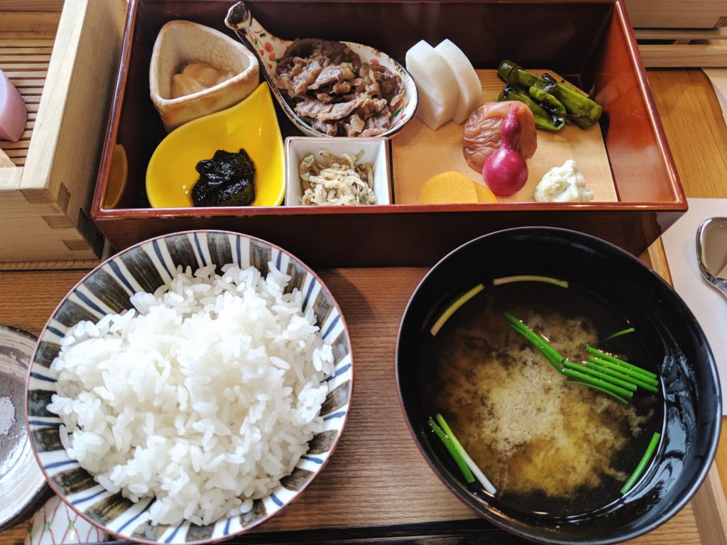 Close up shot of traditional Japanese breakfast with rice, miso soup, and pickled vegetables