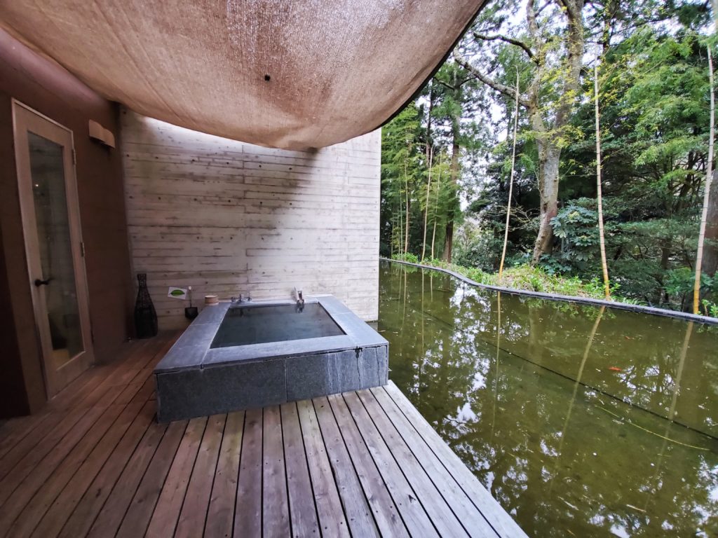 Open air hot spring tub next to a pod at Kinnotake Tonosawa in Hakone, Japan