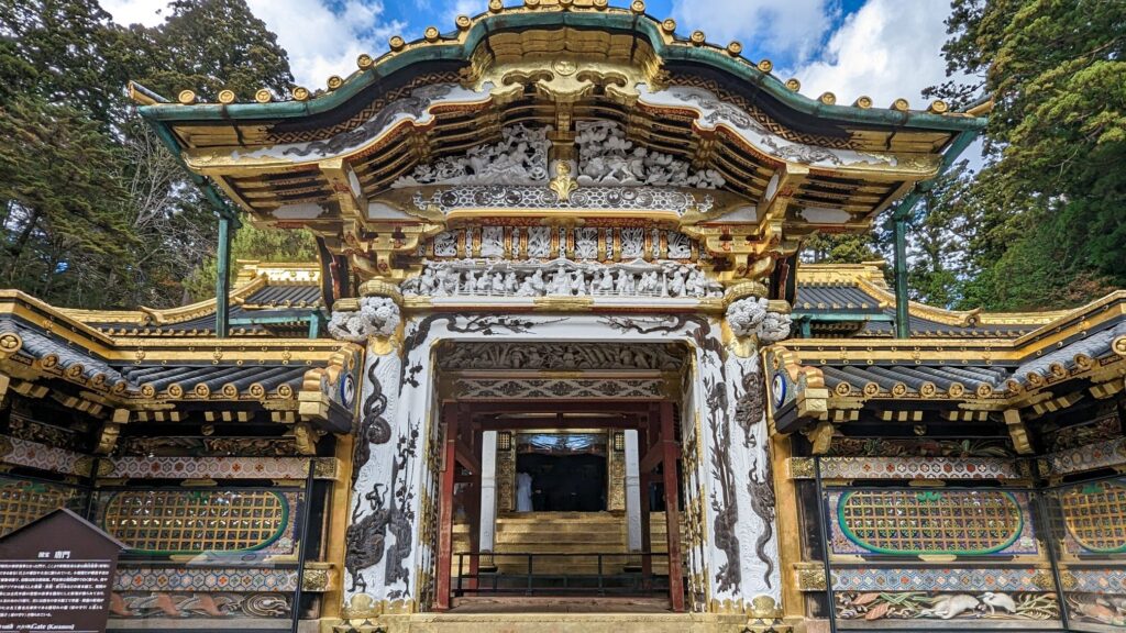 Ornate gold and white gate at the entrance to Toshogu Shrine