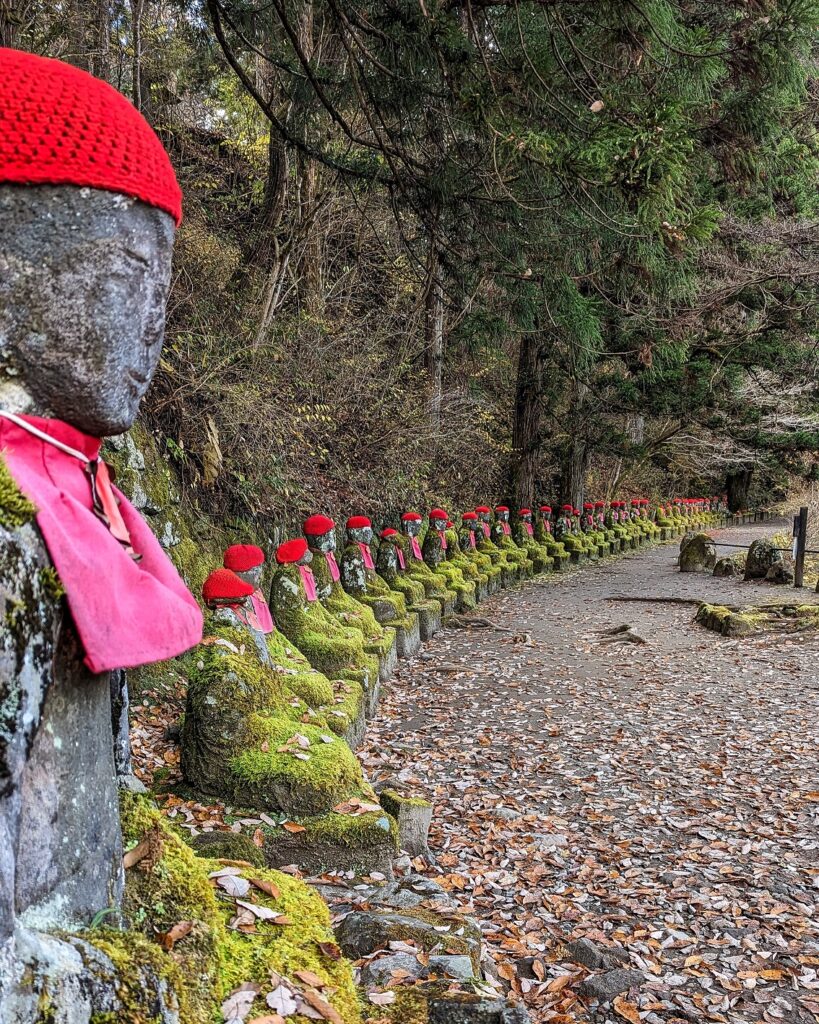 Jizo Buddhist statues with red hats lined up