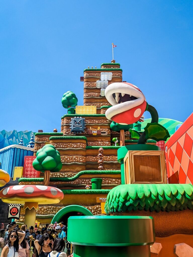 Colorful theming of Super Nintendo World in Universal Studios. Featuring a Piranha Plant