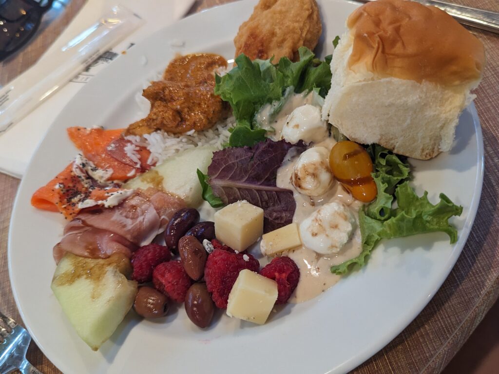 A plate of various foods from the VIP Experience Buffet