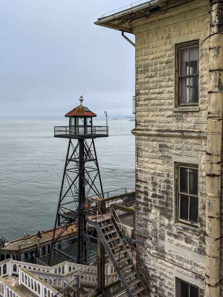 Looking towards a bay with an old lighthouse and an old building in the midground