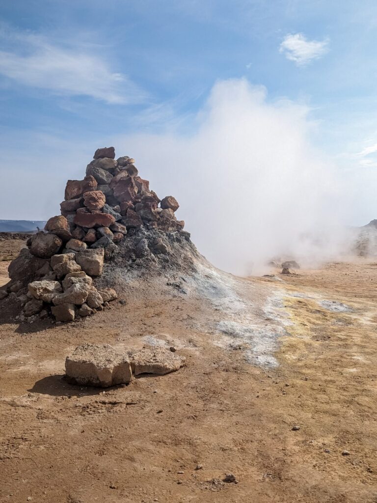 fumarole with a pile of brown rocks places on top of it