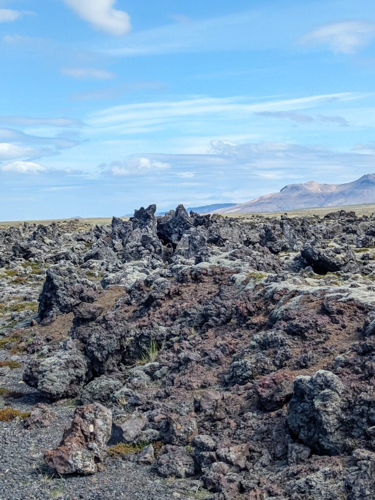 Jagged lava field with a mountain in the background