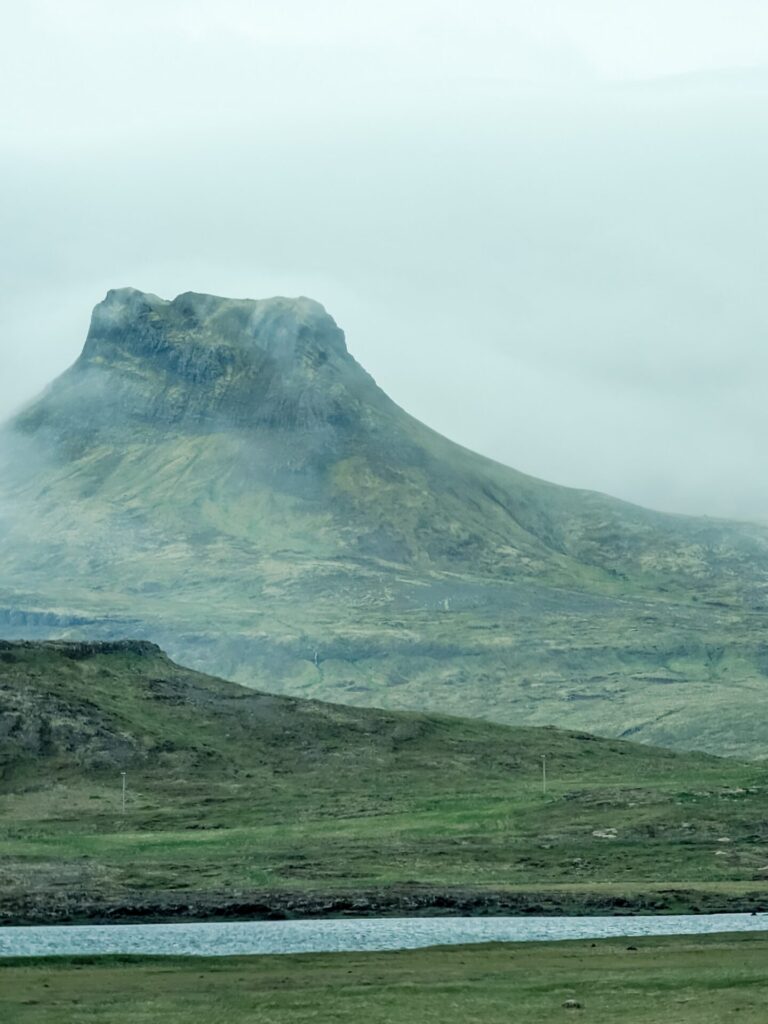 Mossy flat topped mountain covered in fog