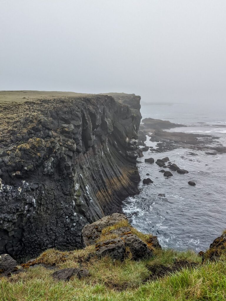 black basalt cliff running along the ocean.