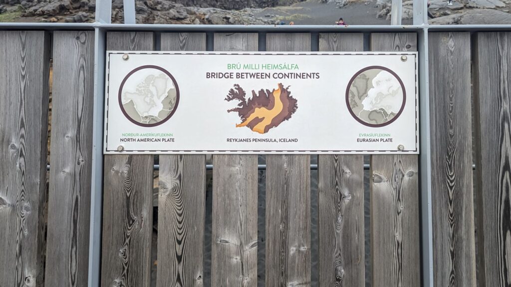 A sign that says "Bridge Between Continents" with two photos of the North American Tectonic Plate and Eurasian Tectonic Plate.