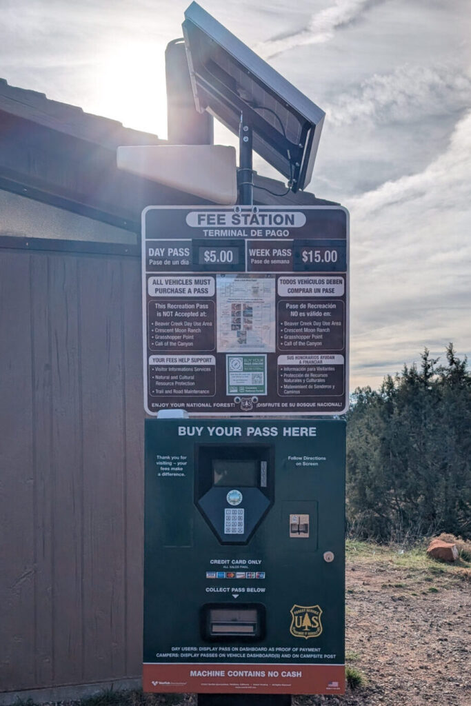 A green and red parking pass kiosk that sells Red Rock Passes