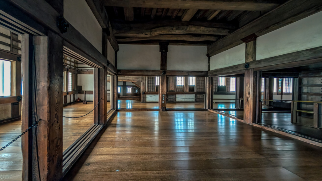 The inside of Himeji castle, minimalist room with wooden floors and wooden beams