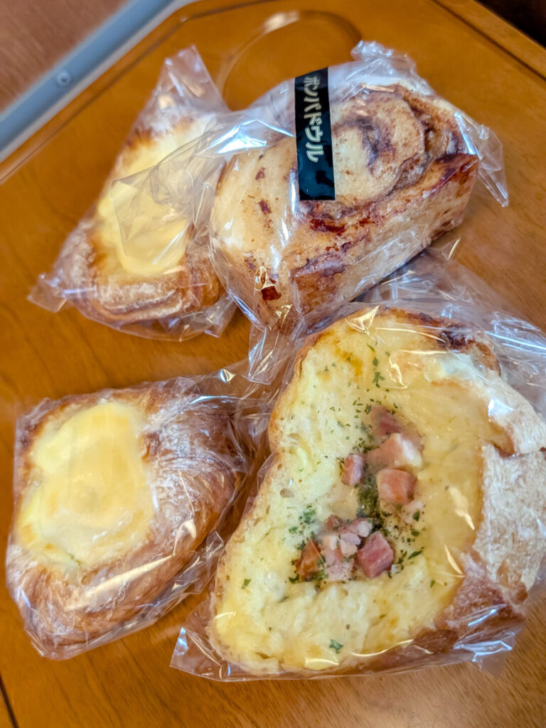 4 different pastries wrapped in plastic sitting on a table