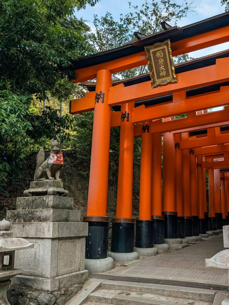 Vibrant orange torii gates lining the hiking trail at Fushimi Inari Taisha.