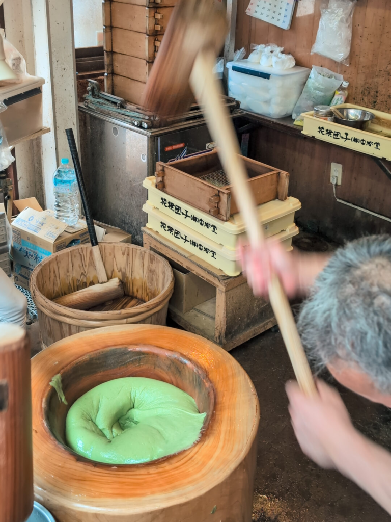 High-speed traditional mochi pounding demonstration inside Nakatanidou shop in Nara.