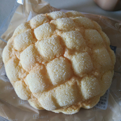 Melon pan from a Japanese convenience store. Fluffy half circle pastry bread with a square pattern on the top