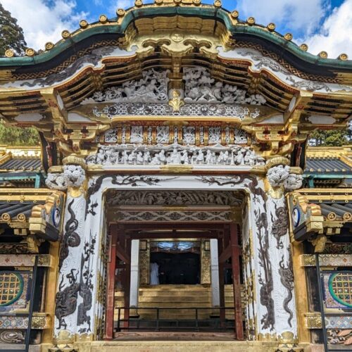 Ornate gold and white gate at the entrance to Toshogu Shrine