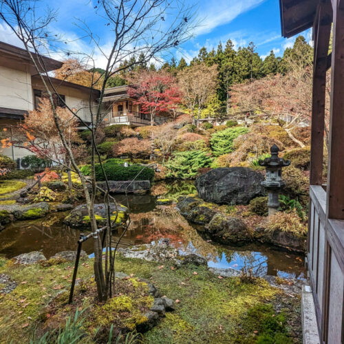 Japanese garden with vibrant fall leaves in the courtyard of Okunoin Hotel Tokugawa